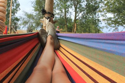 Low section of man relaxing on hammock