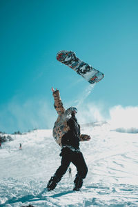 Full length of man playing in snow