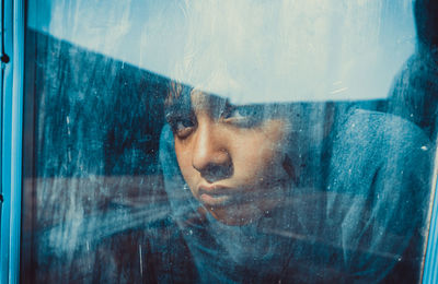 Close-up of woman seen through window