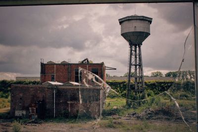 Old water tower against sky