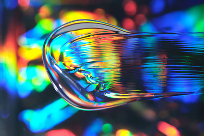 Drop of cosmetic transparent gel on a halographic background. 