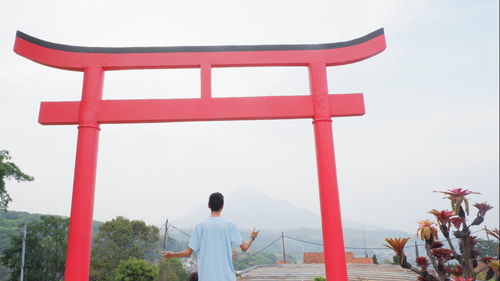 Rear view of man standing against sky