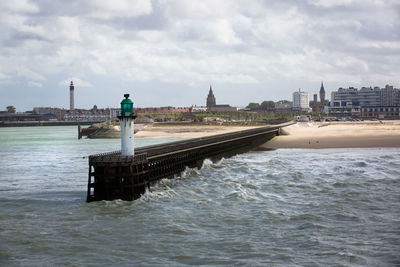 Bridge over river against buildings in city