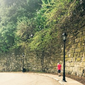 Woman walking on footpath