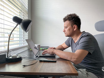 Side view of man working at home