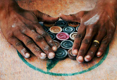 Cropped hands arranging carrom men