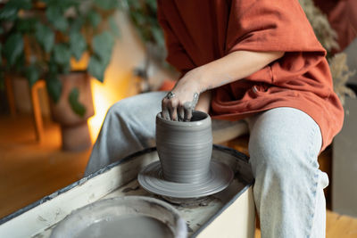 Midsection of man working in workshop