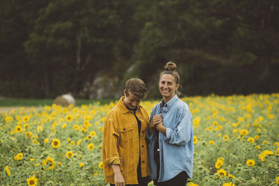 Couple on flowering sunflower field