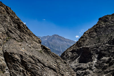 Scenic view of mountains against clear blue sky