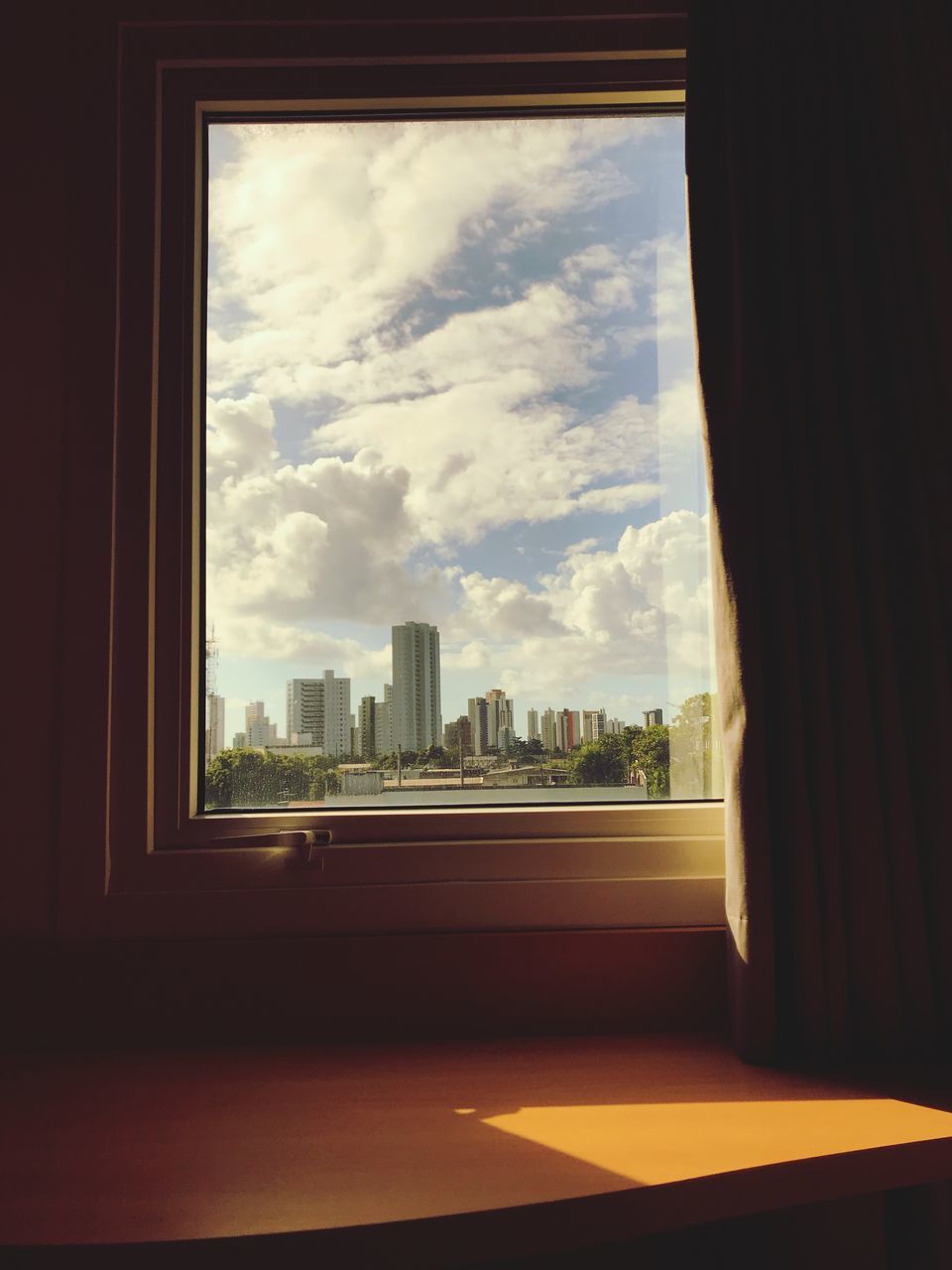 CITY BUILDINGS SEEN THROUGH WINDOW