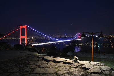 Illuminated suspension bridge at night