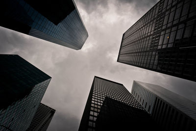 Low angle view of modern building against cloudy sky