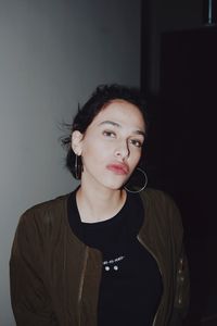 Portrait of beautiful woman standing against wall