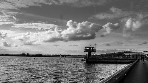 Scenic view of river against sky in city