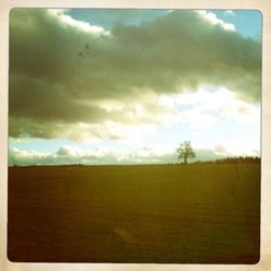 Scenic view of landscape against cloudy sky