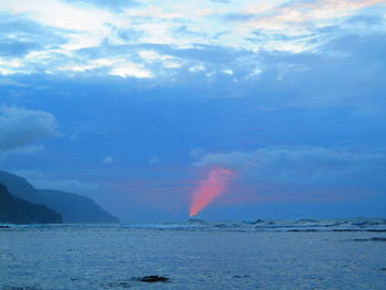 Scenic view of sea against rainbow in sky