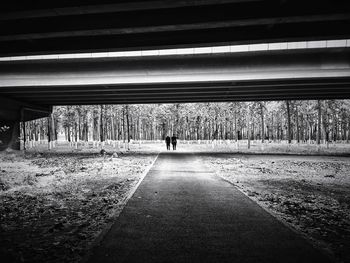 Rear view of man standing on road