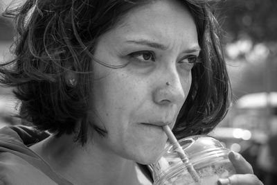 Close-up portrait of young woman looking away