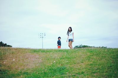 Full length of man standing on grassy field