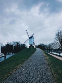 Traditional windmill on field against sky