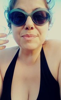 Close-up portrait of young woman wearing sunglasses