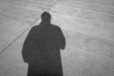 Shadow of person on footpath