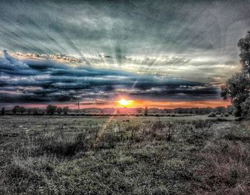 Scenic view of field against sky during sunset