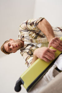 Close-up of woman holding toy on bed at home