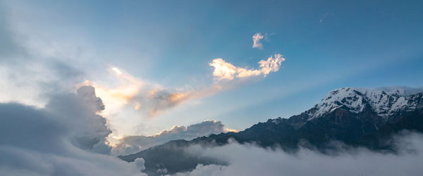 Low angle view of snowcapped mountains against sky during sunset