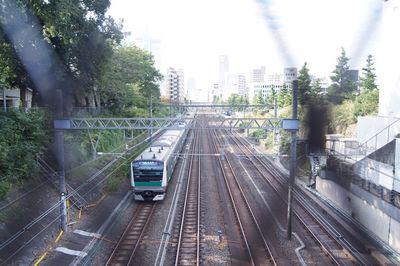 High angle view of moving steps leading towards city against sky