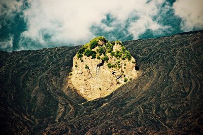 Scenic view of mountains against cloudy sky