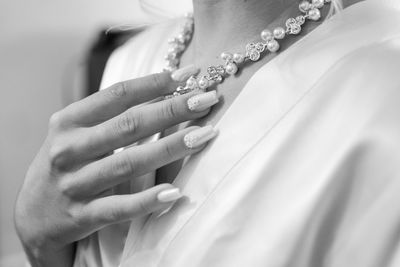 Midsection of bride holding wedding dress