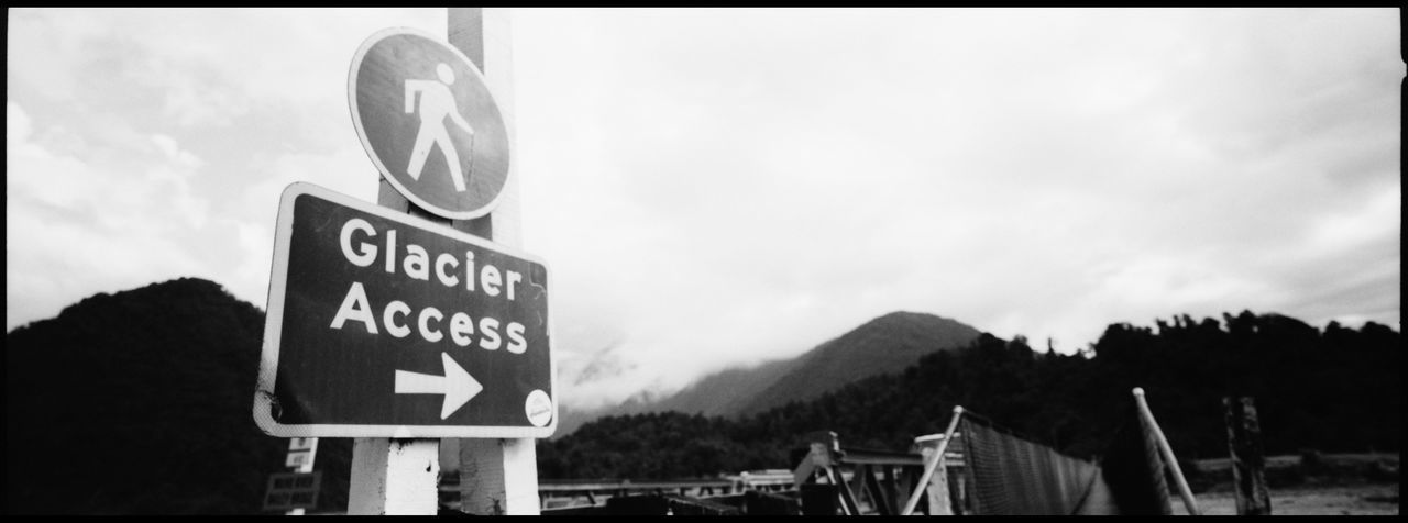 ROAD SIGN AGAINST SKY