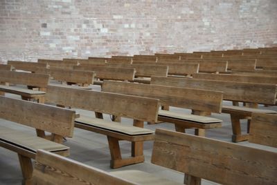 Empty chairs and tables in row