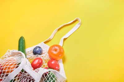 Close-up of fruits against yellow background