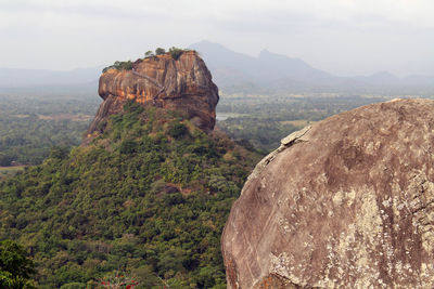 Rock formations on landscape against sky