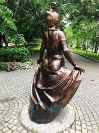 Statue on footpath in park