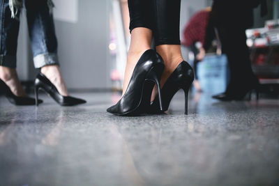 Low section of models in stilettos at backstage