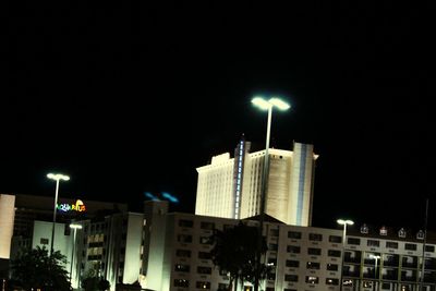 Low angle view of modern building against sky at night