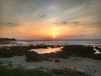 Scenic view of beach at sunset