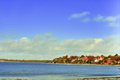 Scenic view of beach against blue sky