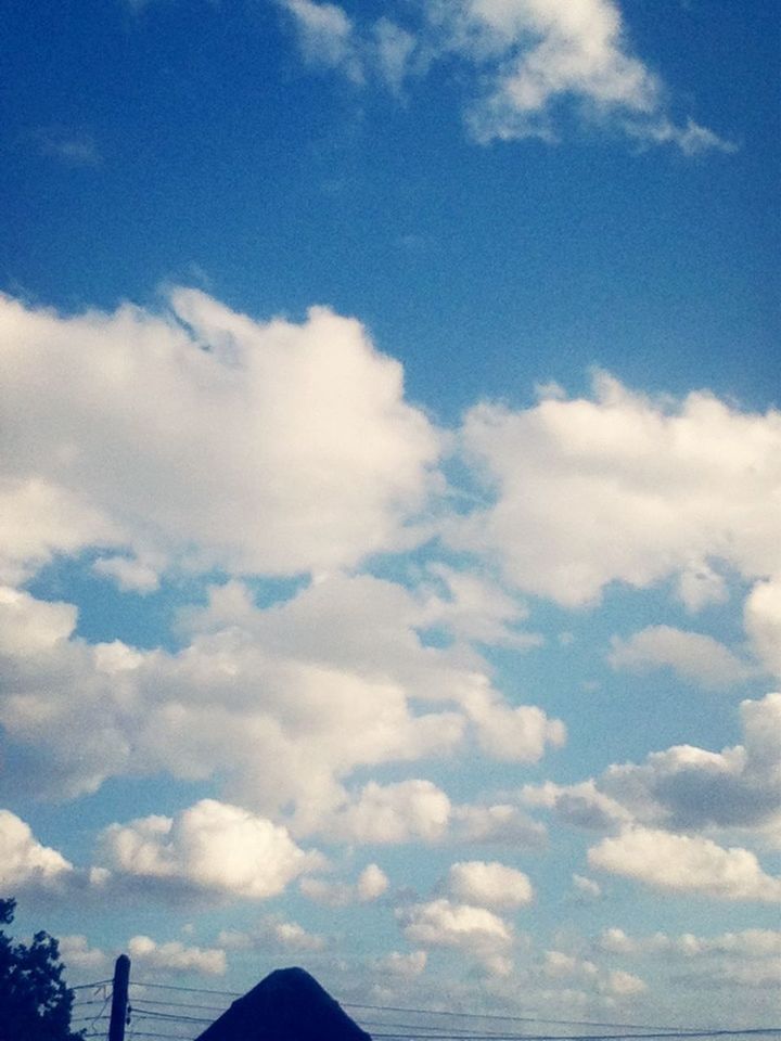 sky, blue, low angle view, cloud - sky, beauty in nature, tranquility, scenics, tranquil scene, cloud, nature, cloudy, white color, cloudscape, idyllic, day, outdoors, no people, silhouette, white, majestic