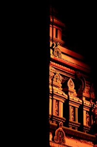 Low angle view of clock tower at night