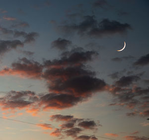 Low angle view of moon against sky at sunset
