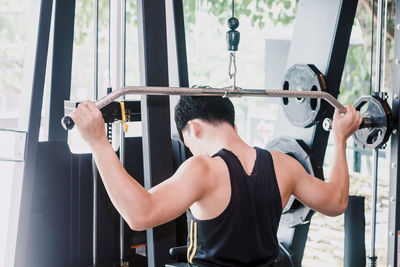 Man lifting barbell in gym