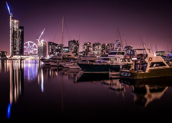 Boats moored at harbor