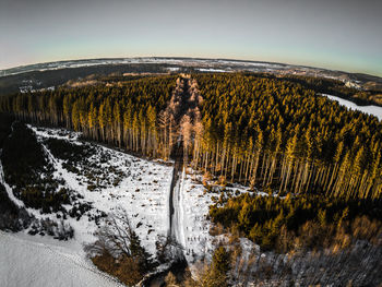 Scenic view of snow covered land against sky