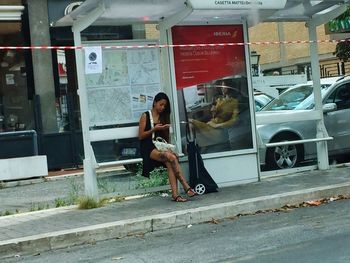 Full length portrait of woman sitting in bus