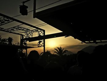 Silhouette people at observation point against sky during sunset