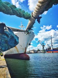 View of harbor against cloudy sky